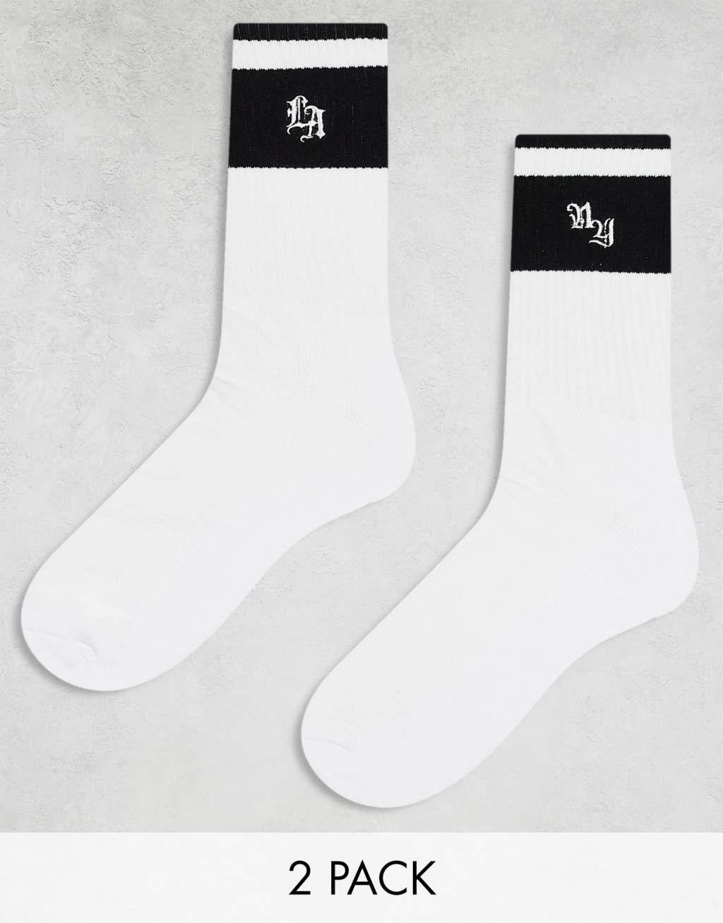 ASOS DESIGN 2 pack athletic striped socks with LA and NY artwork in white Product Image