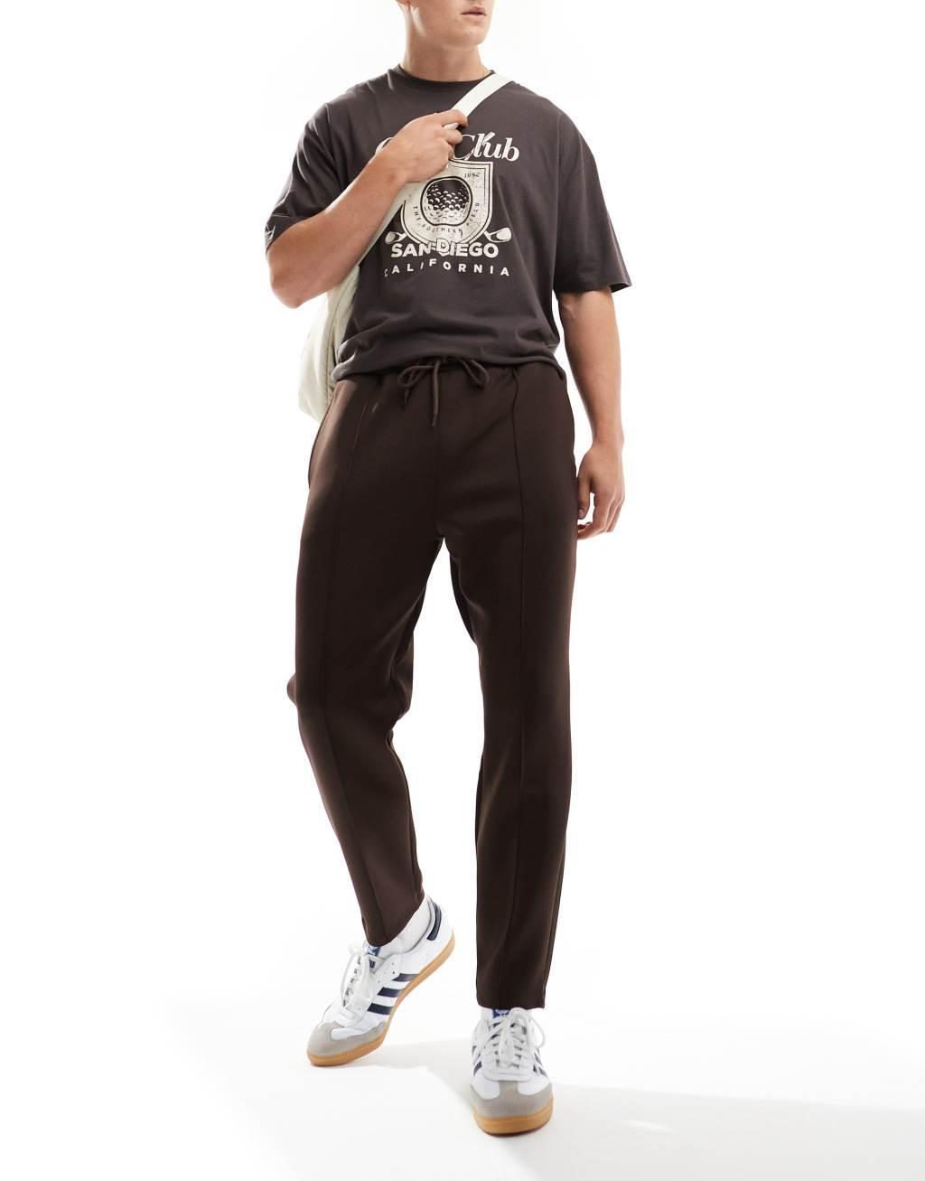 ASOS DESIGN tapered scuba sweatpants in brown Product Image