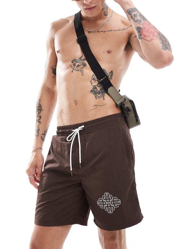 The Couture Club script print swim shorts in brown Product Image