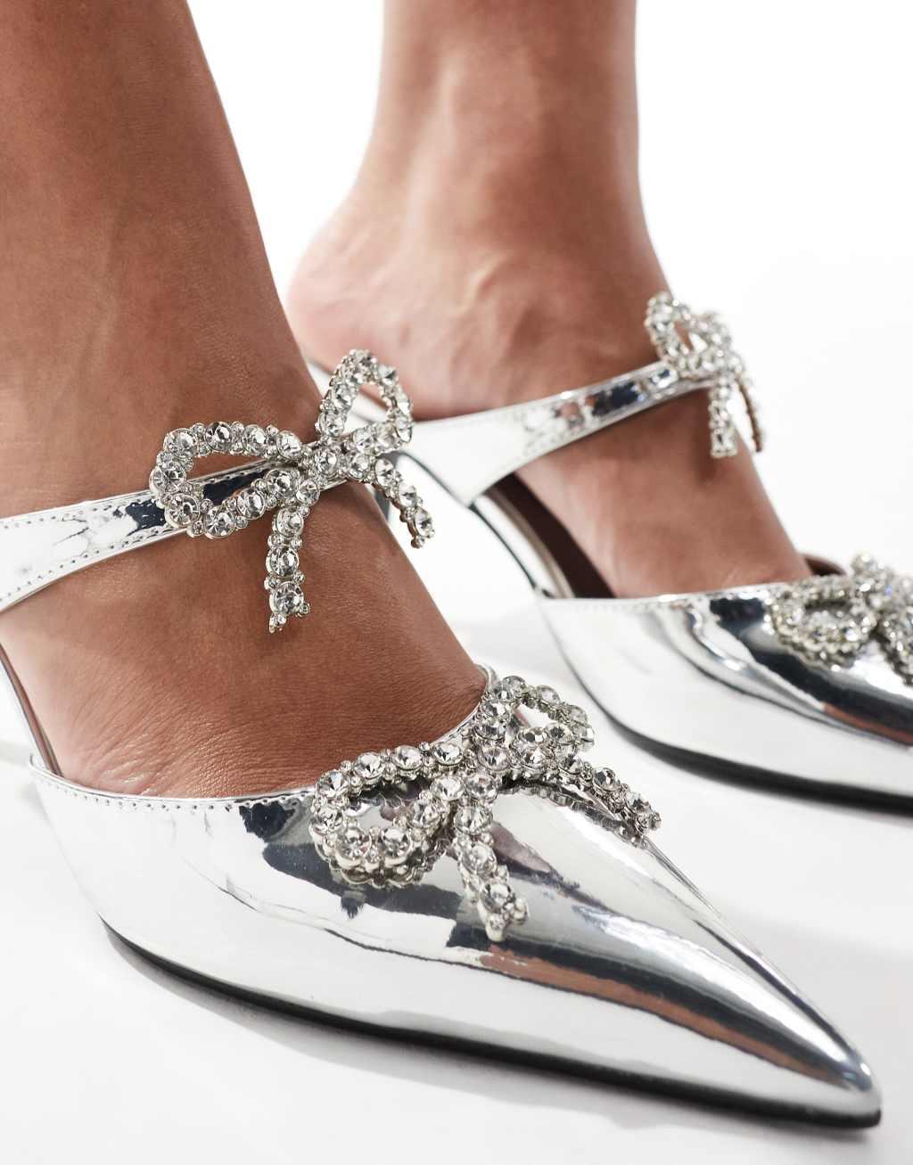 Glamorous embellished bow heeled mules in silver Product Image