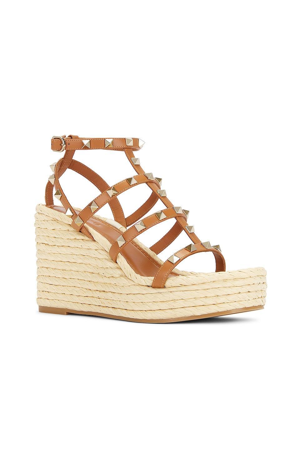 Valentino Garavani Rockstud Espadrille Wedge in Almond Beige & Naturale - Beige. Size 37 (also in 39, 41). Product Image