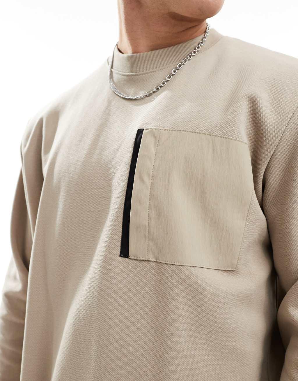 Jack & Jones oversized washed crew neck sweatshirt with nylon pocket in beige Product Image