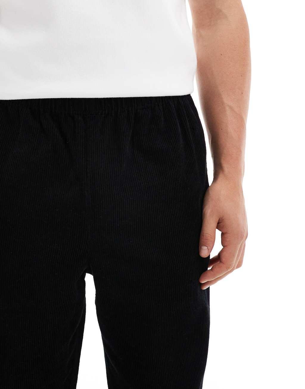 ASOS DESIGN relaxed corduroy pants with side taping in black Product Image