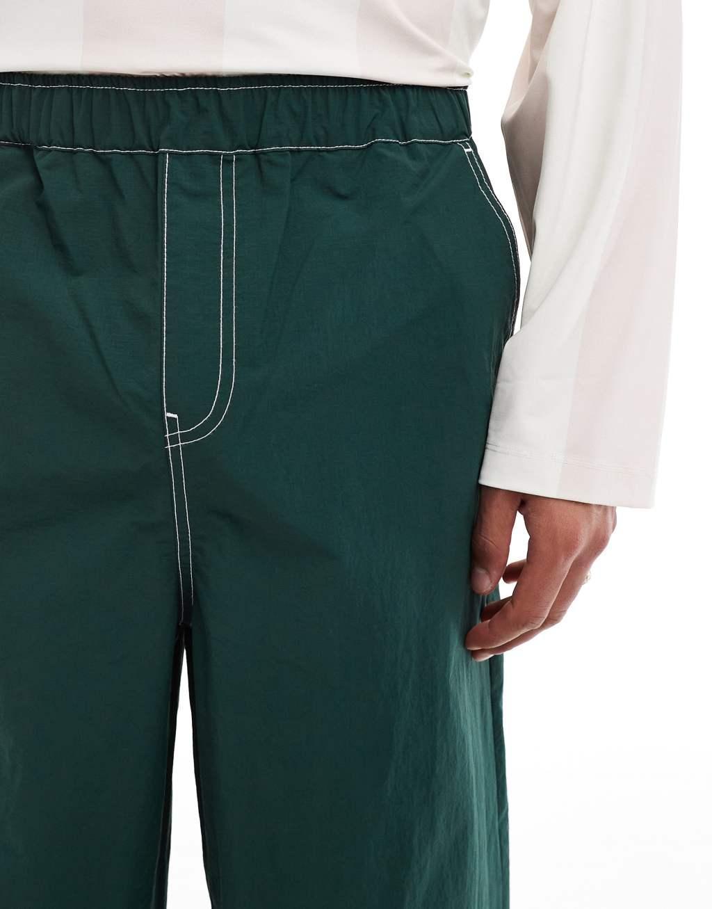 ASOS DESIGN super baggy pant in green nylon with contrast stitch Product Image