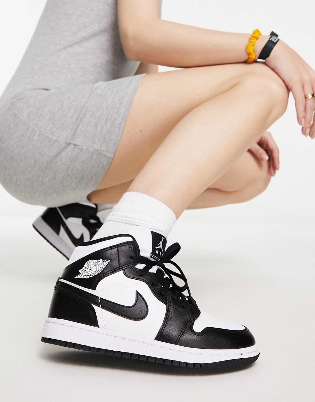 Nike Air Jordan 1 Mid sneakers in white and black  Product Image