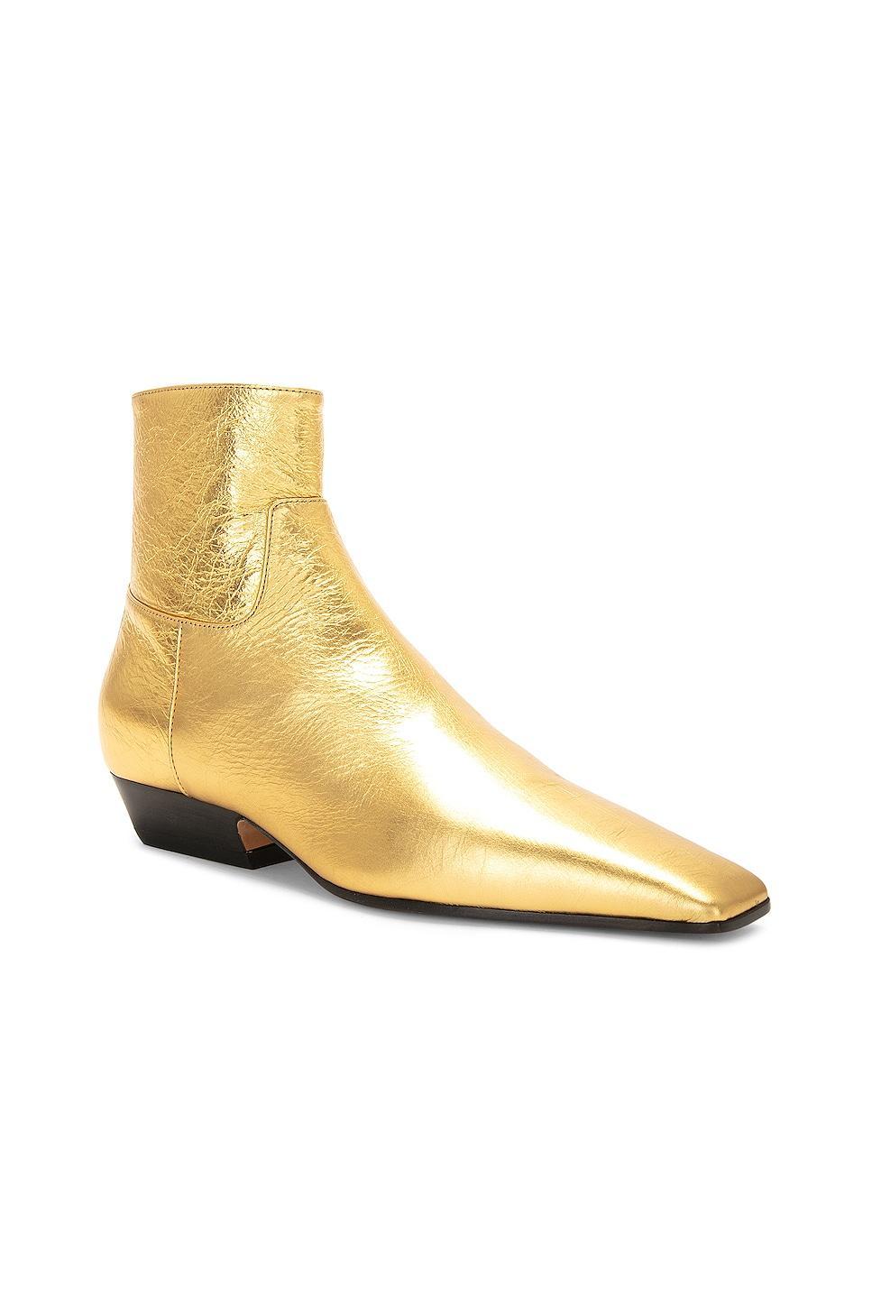 KHAITE Marfa Classic Flat Ankle Boot in Gold - Metallic Gold. Size 37.5 (also in 36.5, 38, 39, 39.5, 40). Product Image