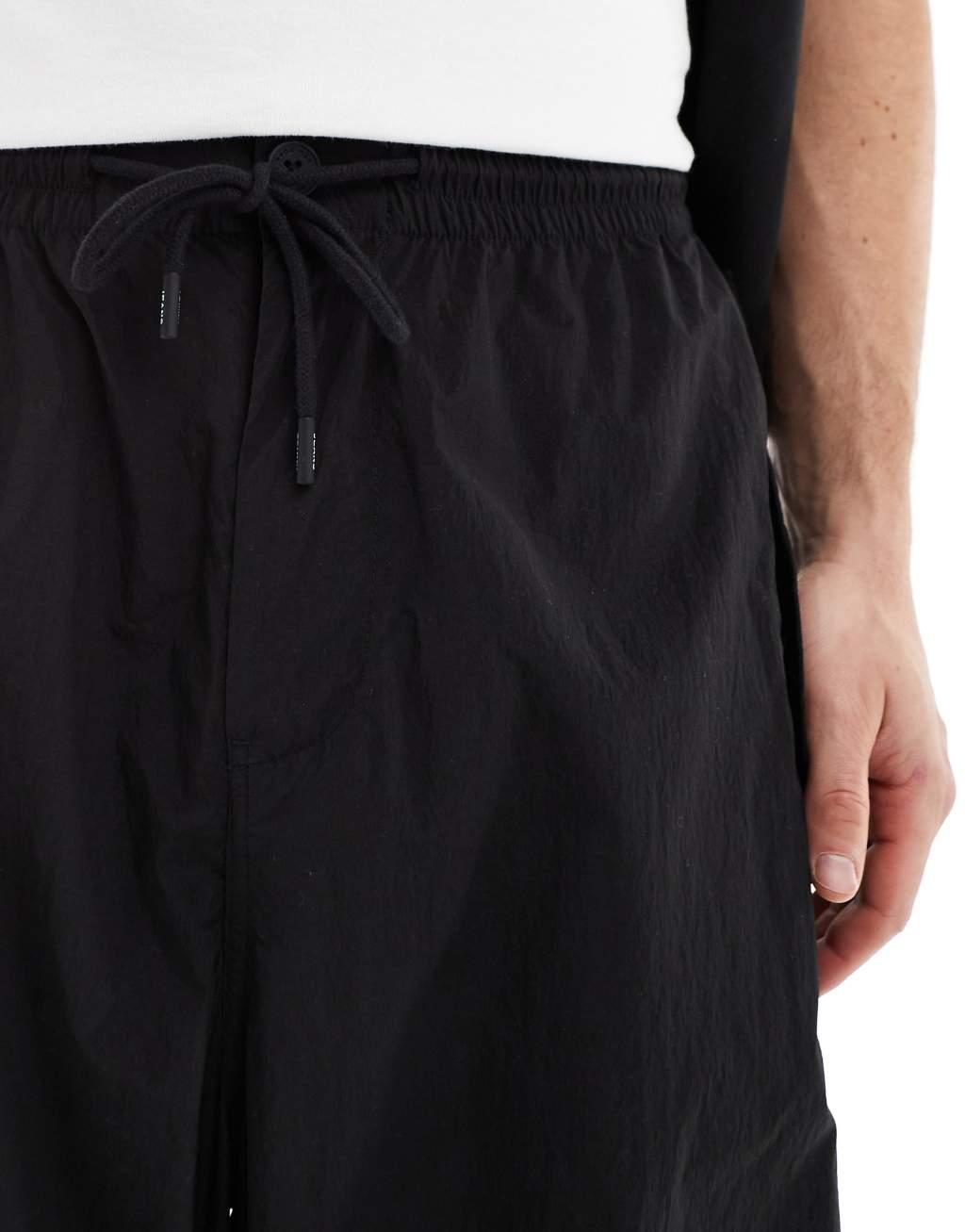 Tommy Jeans nylon parachute pants in black Product Image