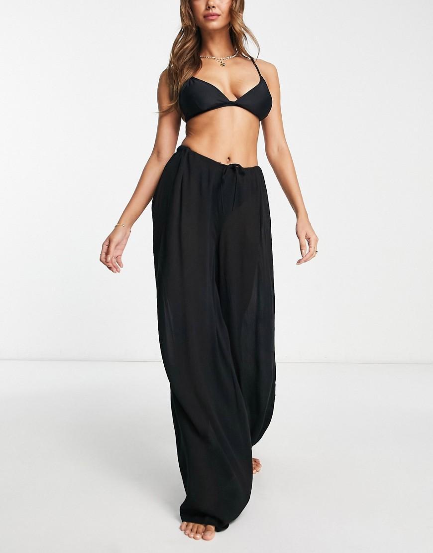 ASOS DESIGN drawstring palazzo beach pants in black Product Image