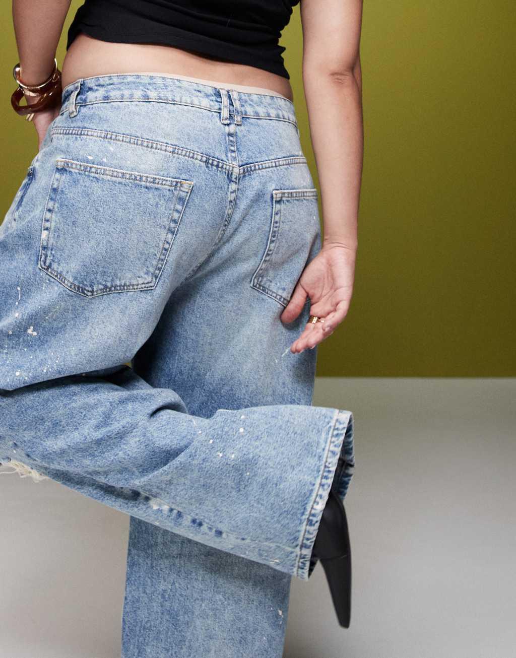 ASOS DESIGN Curve mid rise baggy boyfriend jeans with rips and paint splats in mid blue Product Image