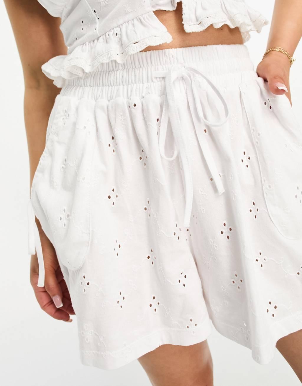 ASOS DESIGN Petite eyelet shorts with tie pockets in white Product Image