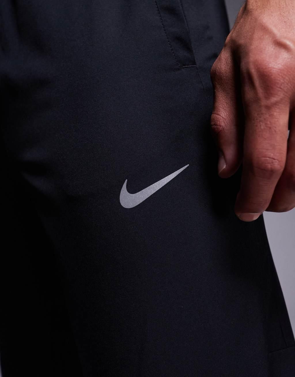 Nike Running Challenger woven sweatpants in black Product Image