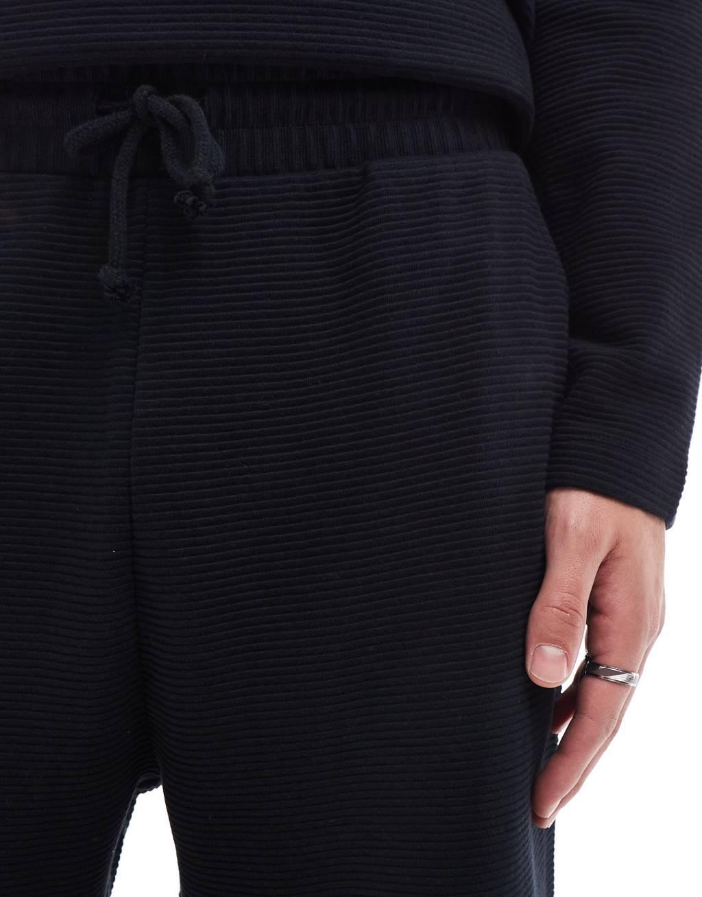 ASOS DESIGN tapered rib sweatpants in black Product Image