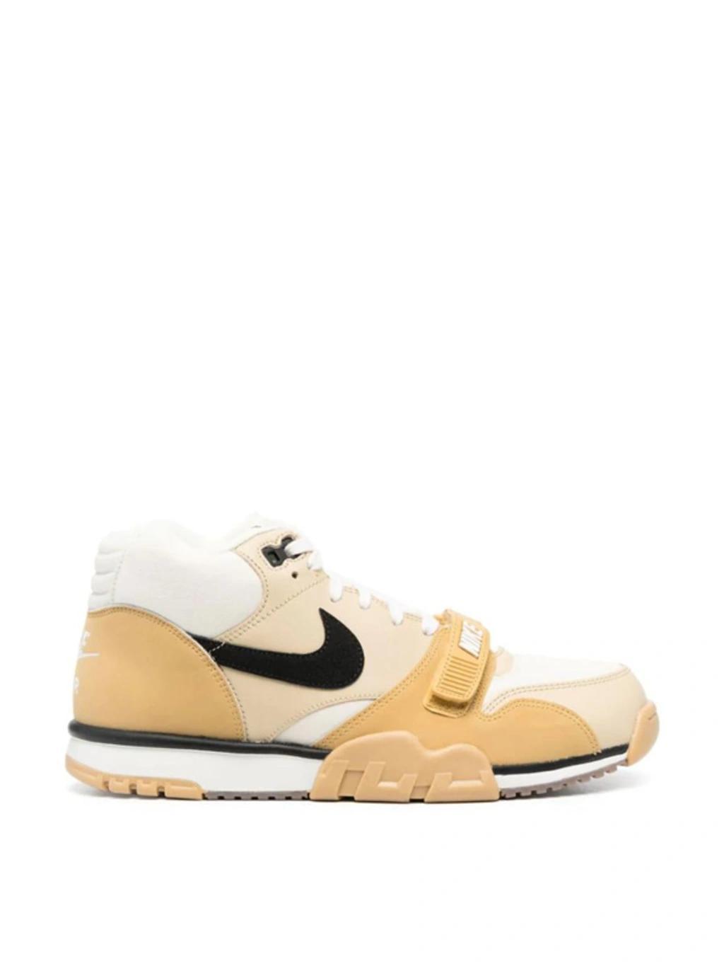 Air Trainer 1 Sneakers Coconut Milk In Coconut Milk/black/team Gold/sail-wheat-gum Dark Brown Product Image