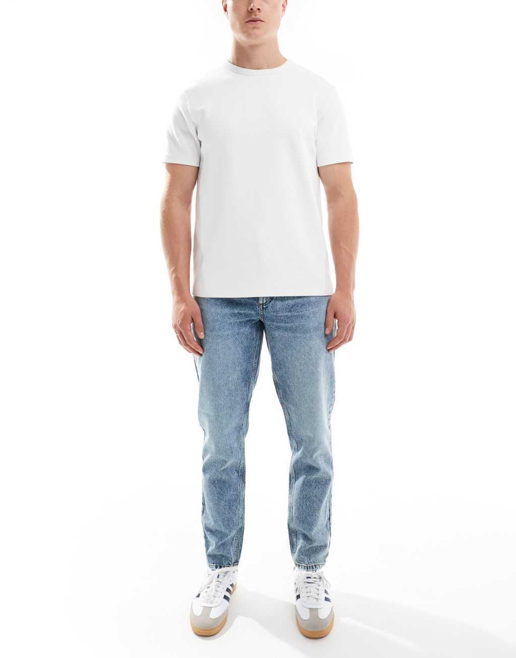 ASOS DESIGN tapered fit jeans in mid wash blue  Product Image