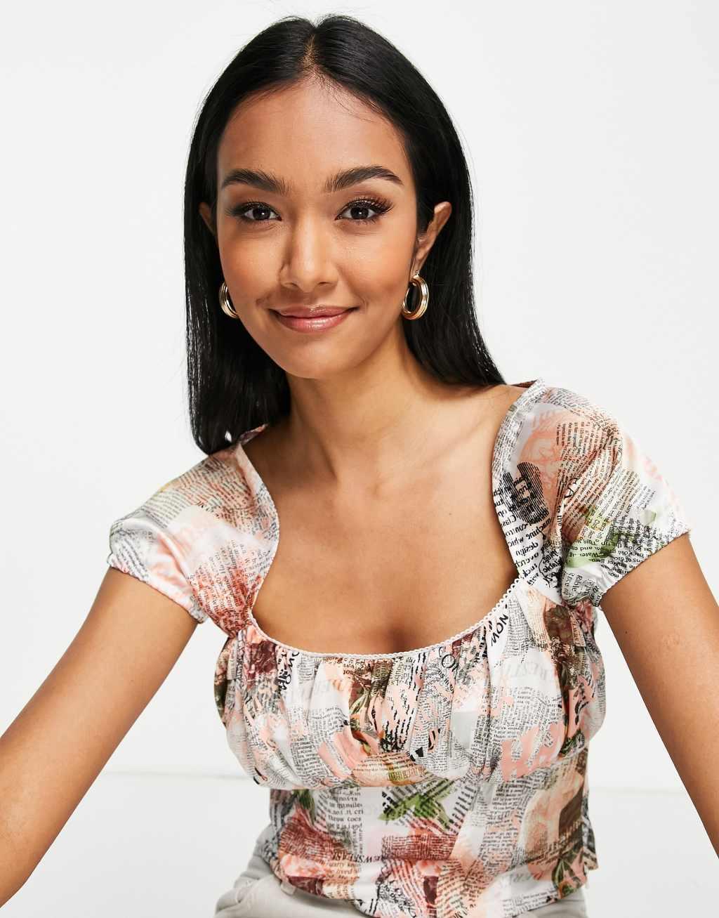 ASOS DESIGN 90s capped sleeve top with corset detail in floral newspaper print Product Image