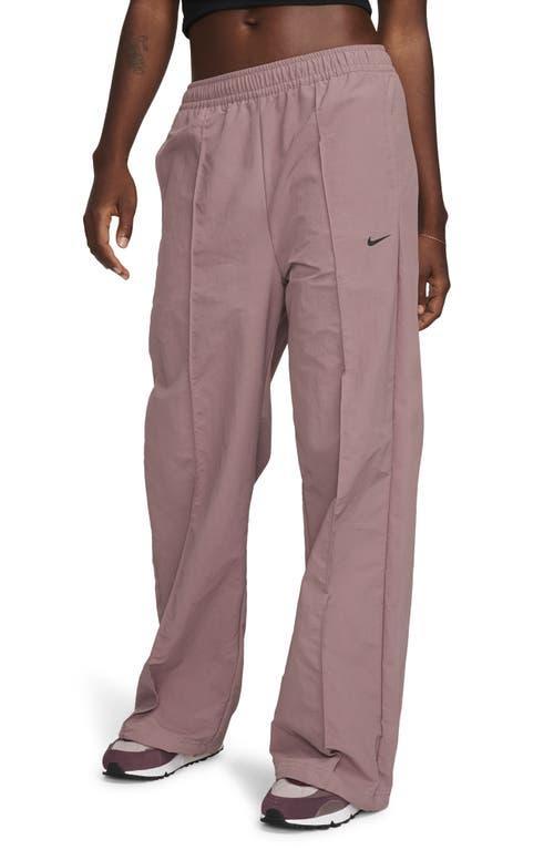 Nike Trend woven baggy parachute pants in smokey mauve Product Image