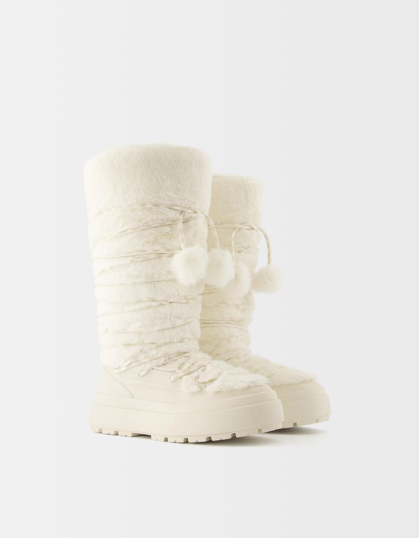 Flat faux fur boots with tassels product image