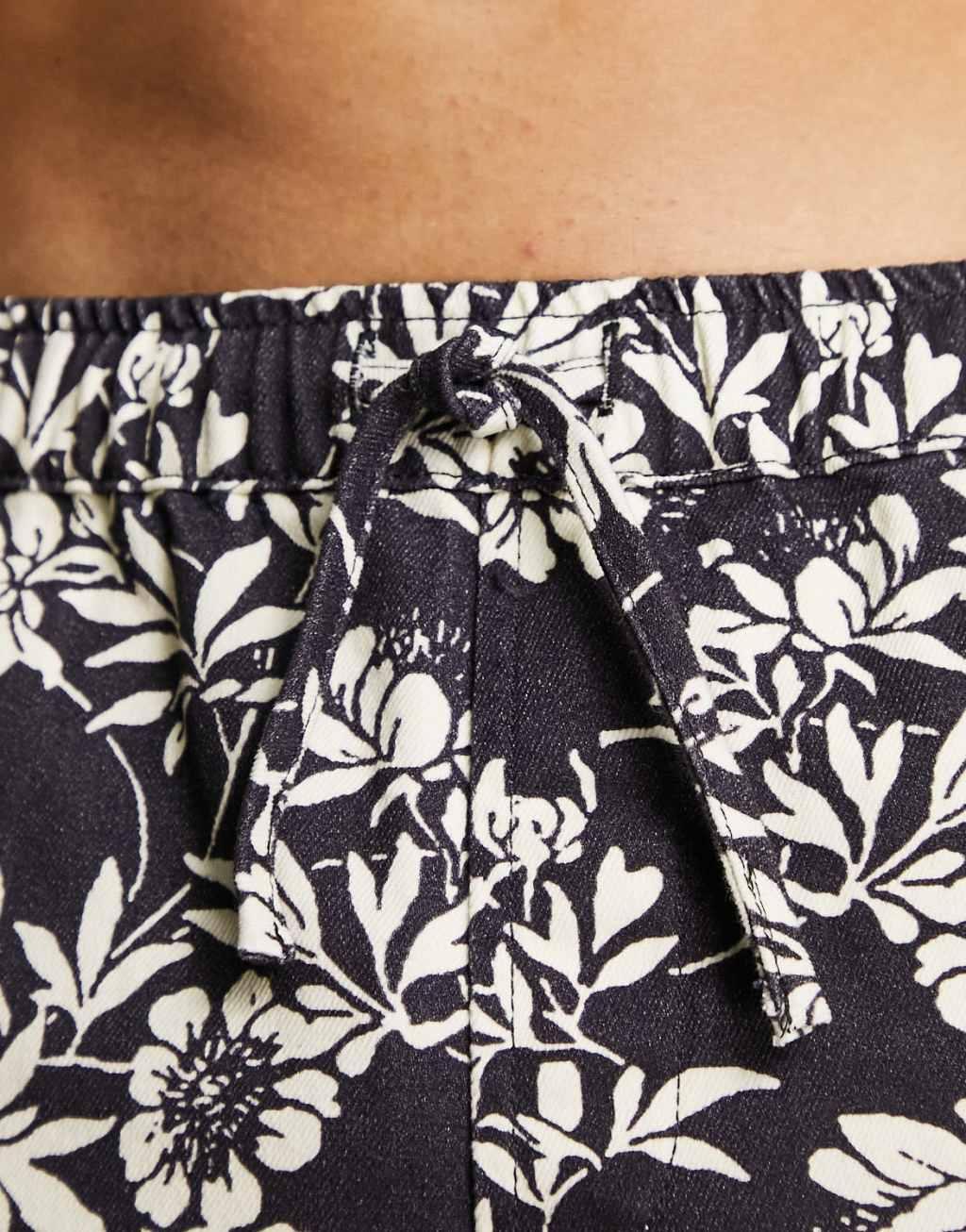 ASOS DESIGN pull on denim cargo shorts in floral print black Product Image