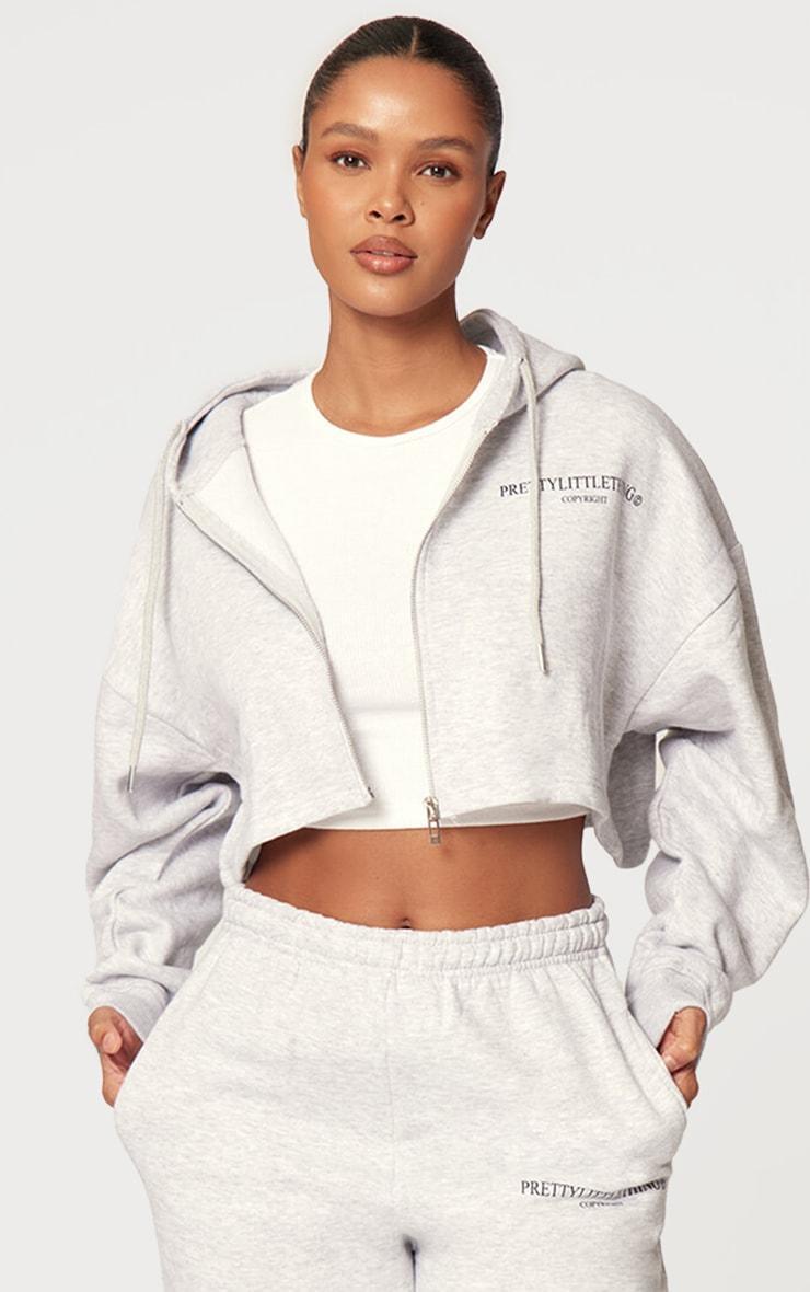 PRETTYLITTLETHING Grey Marl Copyright Graphic Zip Through Crop Hoodie Product Image