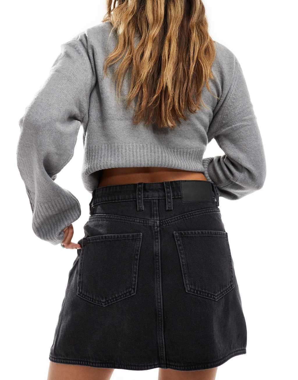 ASOS DESIGN denim mini skirt with cross front waist in wash black Product Image