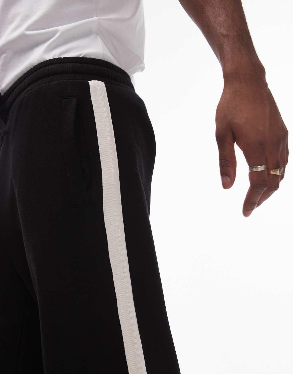 Topman baggy leg sweatpants with contrast side stripe in black Product Image