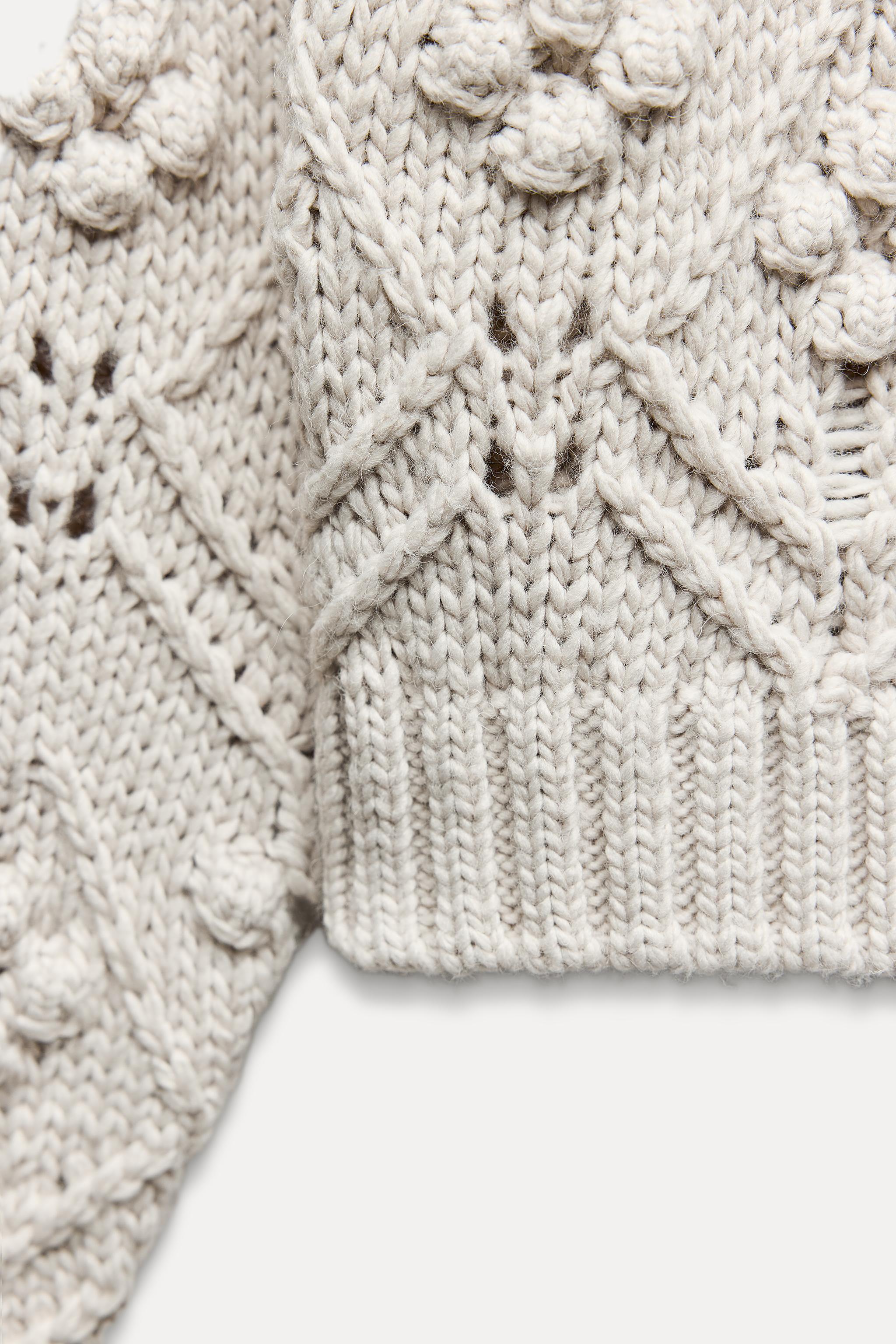 CABLE KNIT SWEATER WITH POMPOMS Product Image