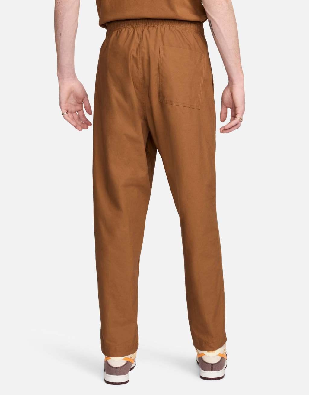 Nike Club woven Barcelona pants in brown Product Image