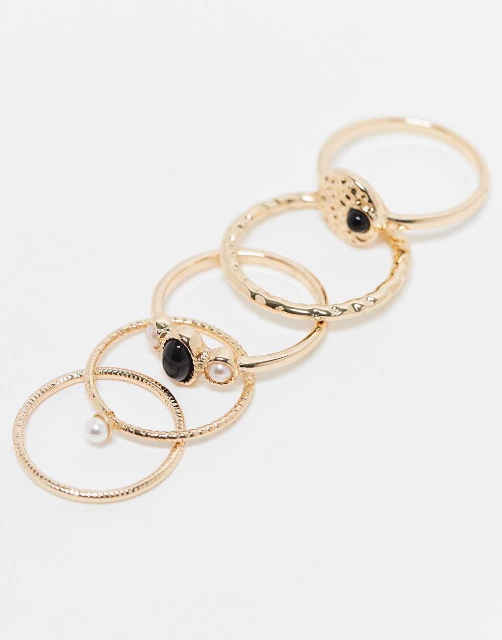 ASOS DESIGN 5-pack rings with black stone and faux pearl design in gold tone Product Image