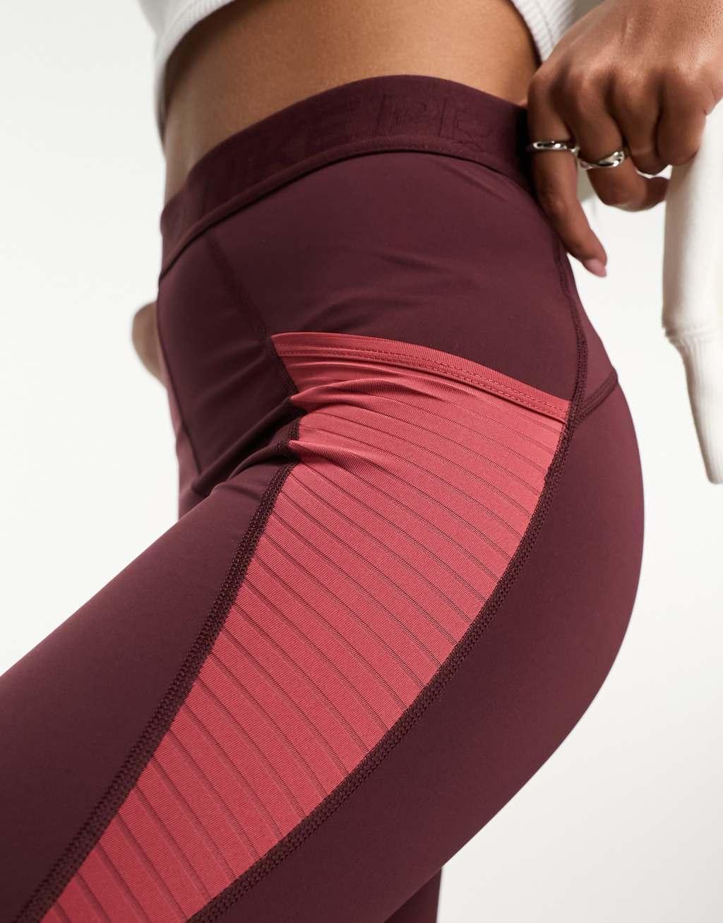 Nike Road To Wellness leggings in burgundy Product Image