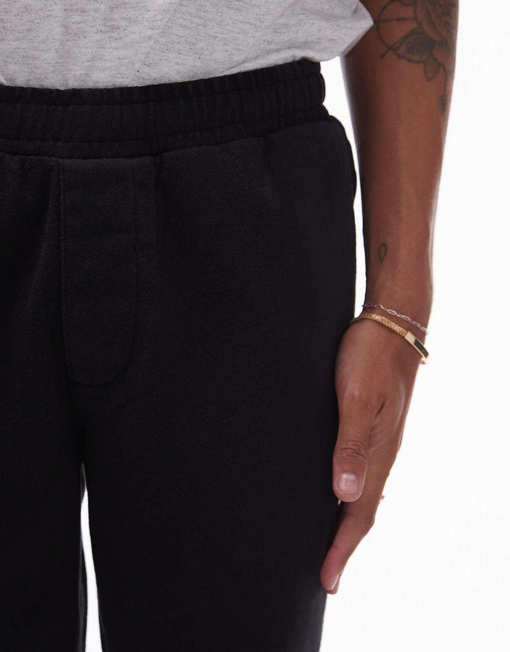 Topman tapered pants with elasticated waistband in black Product Image