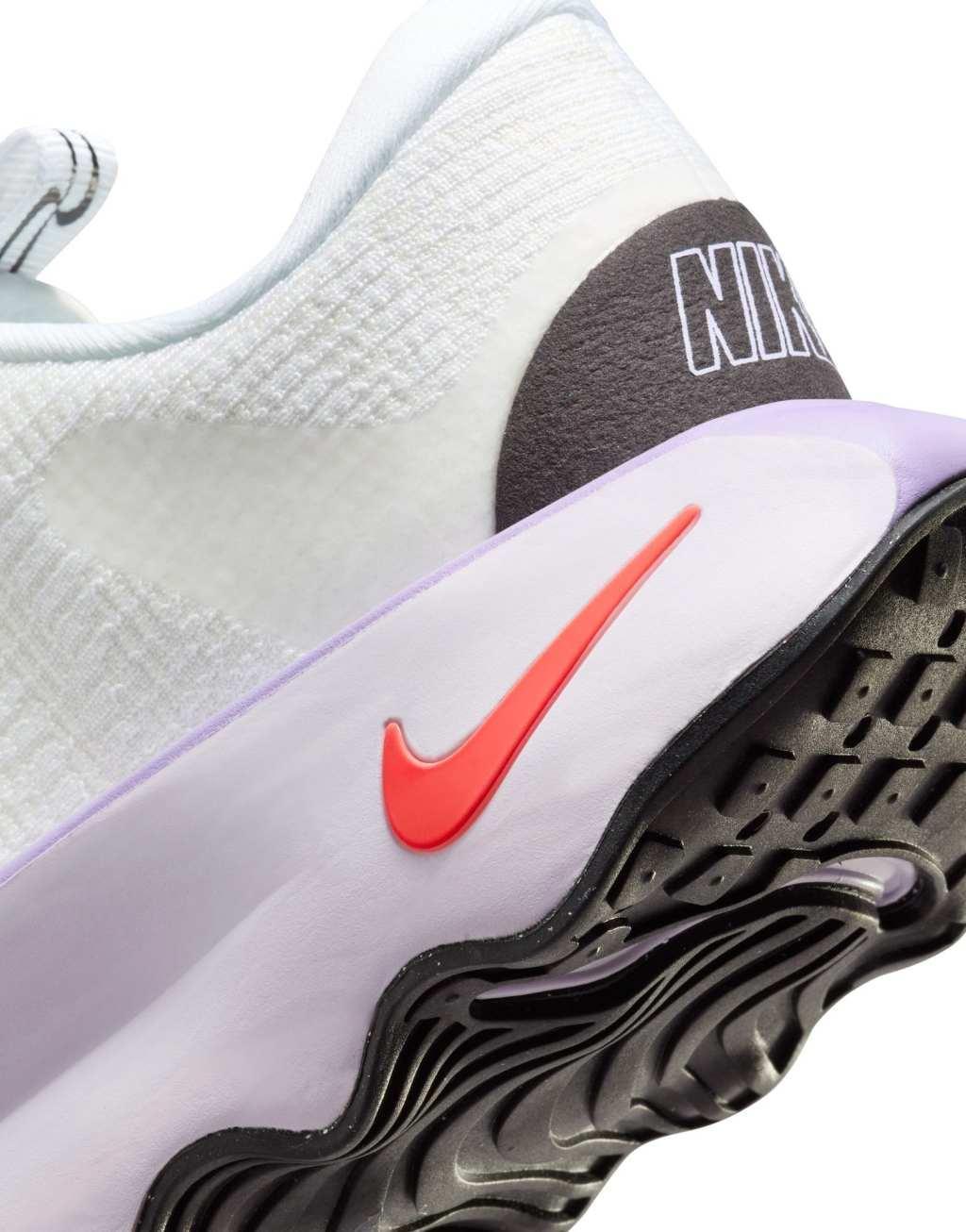 Nike Training Motiva sneakers in white and pink Product Image