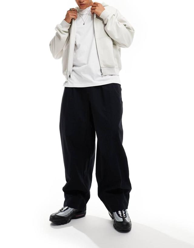 Nike Club woven balloon pants in black Product Image