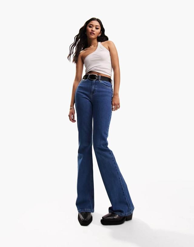 ASOS DESIGN mid rise flare jeans in mid blue Product Image