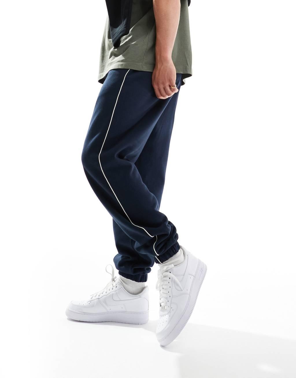 ASOS DESIGN oversized sweatpants with piping in navy Product Image