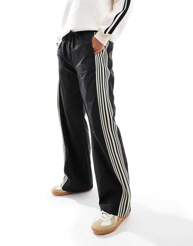 Pull&Bear side stripe wide leg nylon sweatpants in black Product Image