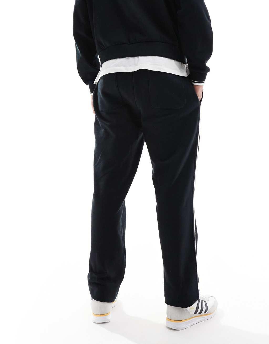 ASOS DESIGN straight leg sweatpants with textured side stripes in black Product Image