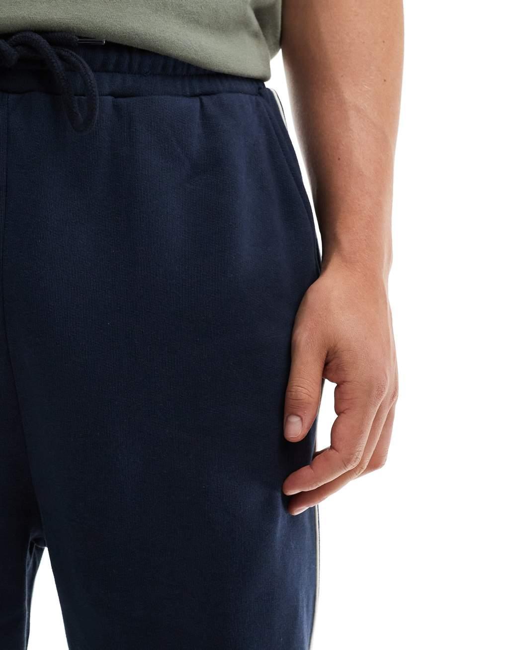 ASOS DESIGN oversized sweatpants with piping in navy Product Image