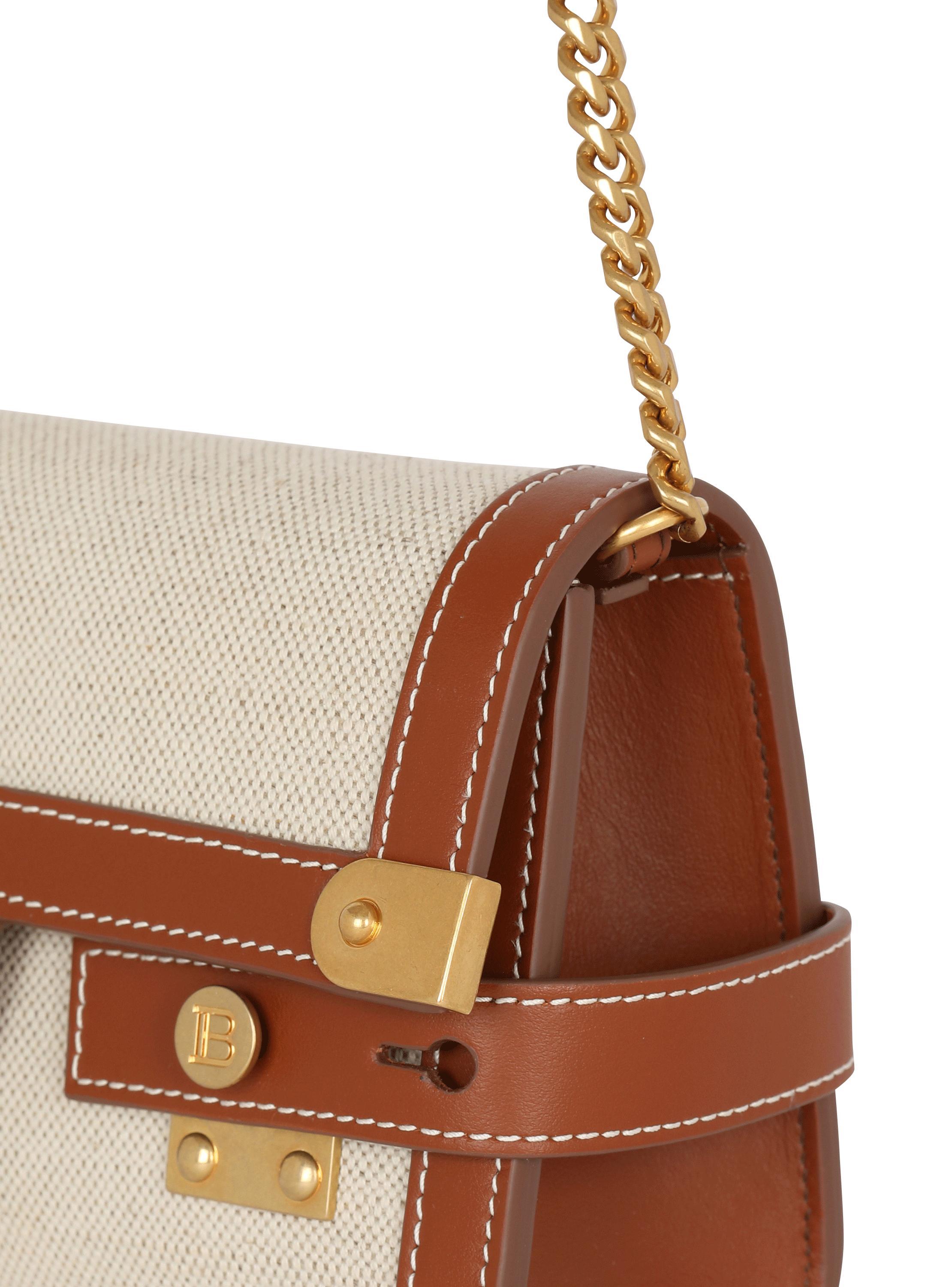 B-Buzz 23 leather and canvas clutch bag Product Image