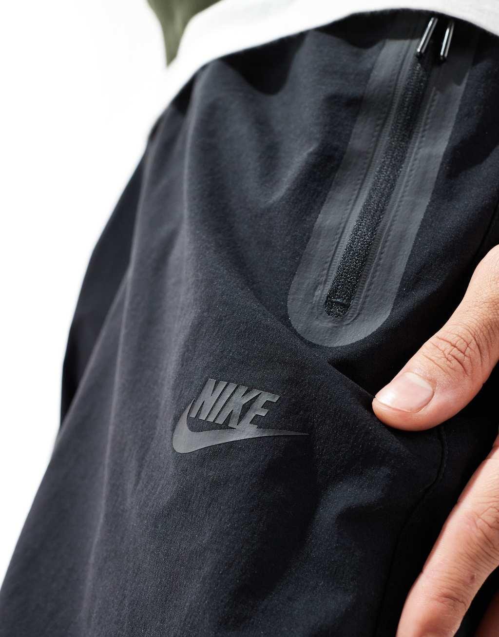 Nike Tech Woven oversized pants in black Product Image