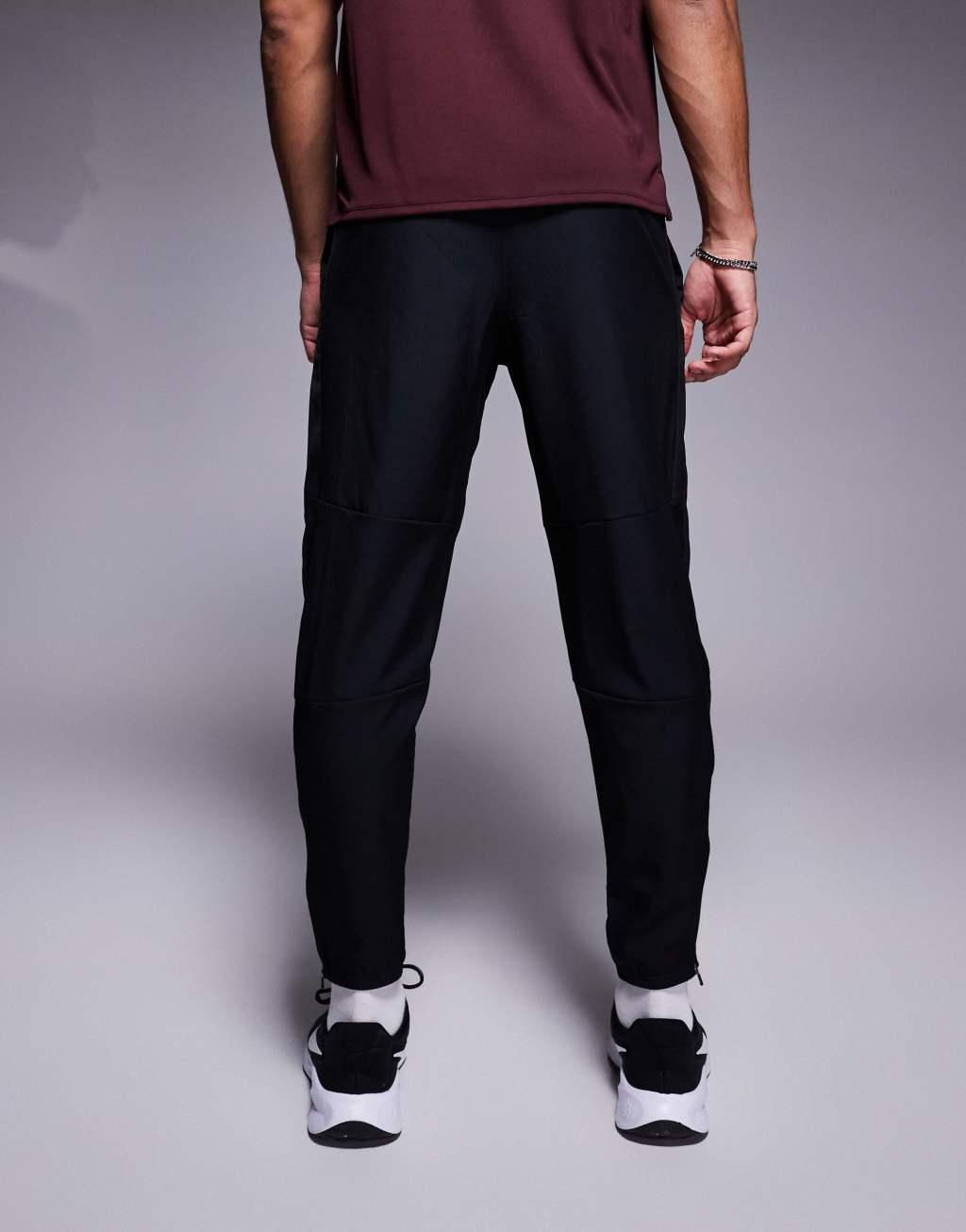 Nike Running Challenger woven sweatpants in black Product Image