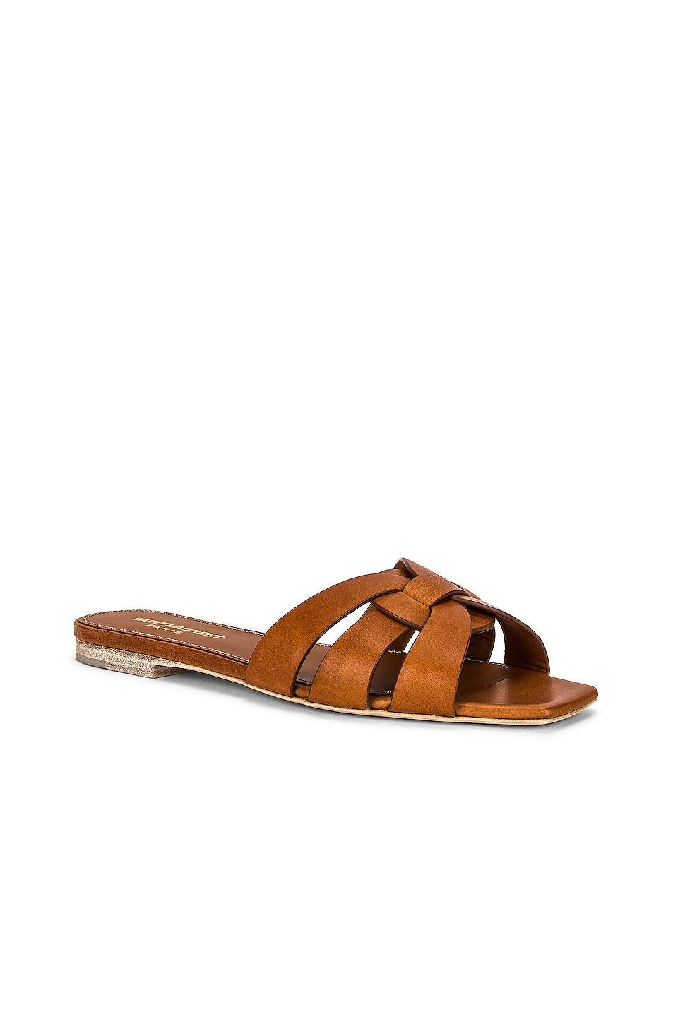 Saint Laurent Tribute Flat Sandal in Amber - Brown. Size 36.5 (also in 37, 38, 39, 40, 40.5, 41). Product Image