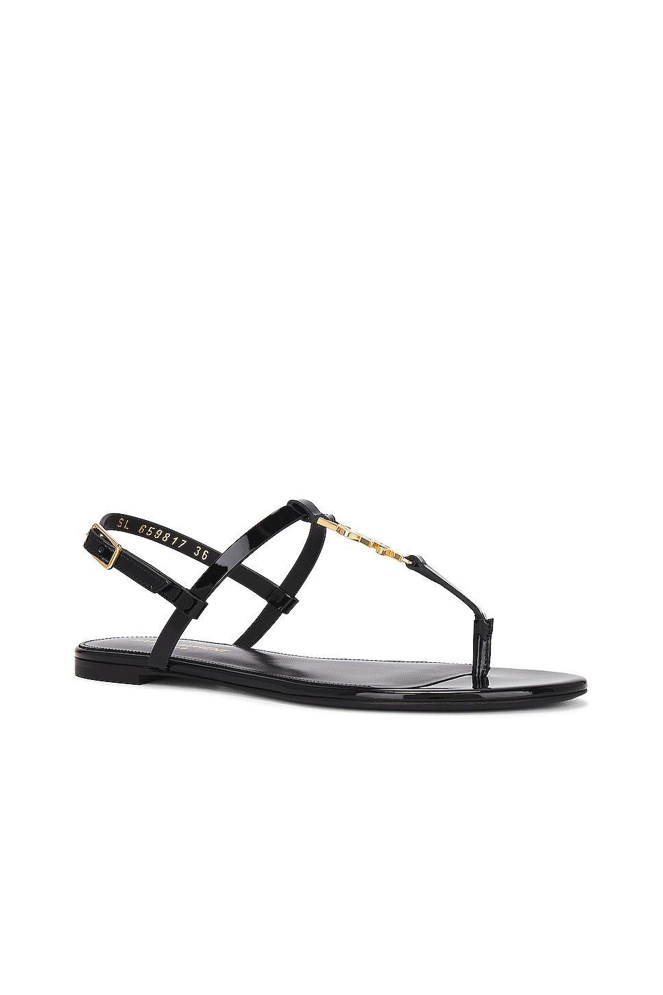 Saint Laurent Cassandra Flat Sandal in Noir - Black. Size 36.5 (also in 37, 38, 40.5). Product Image