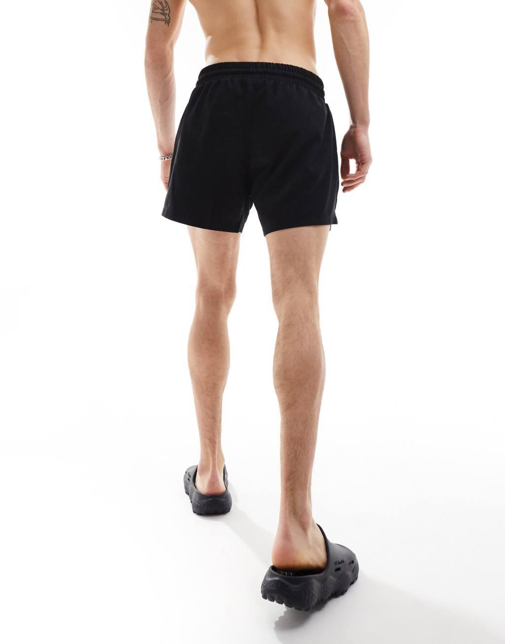 COLLUSION shorter length swim shorts in black Product Image