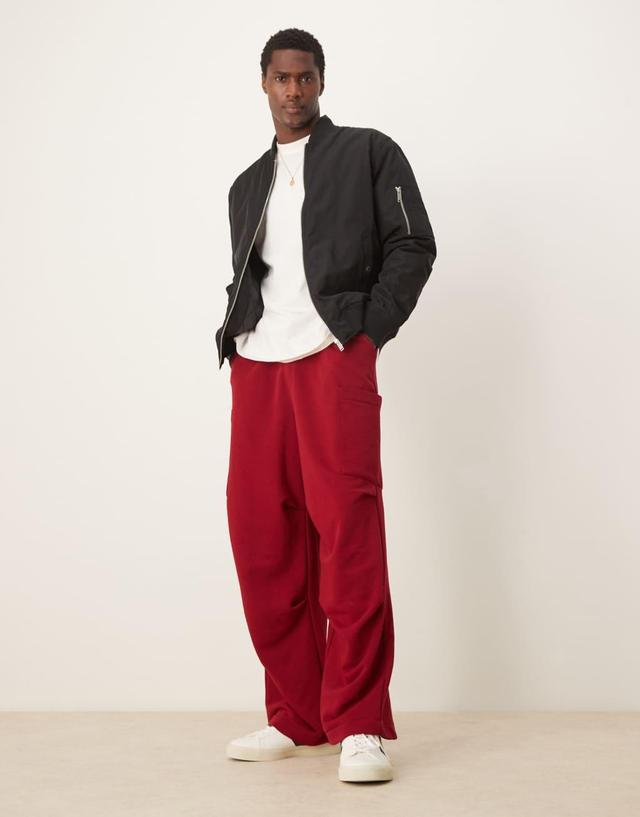 ASOS DESIGN oversized balloon cargo sweatpants in burgundy Product Image