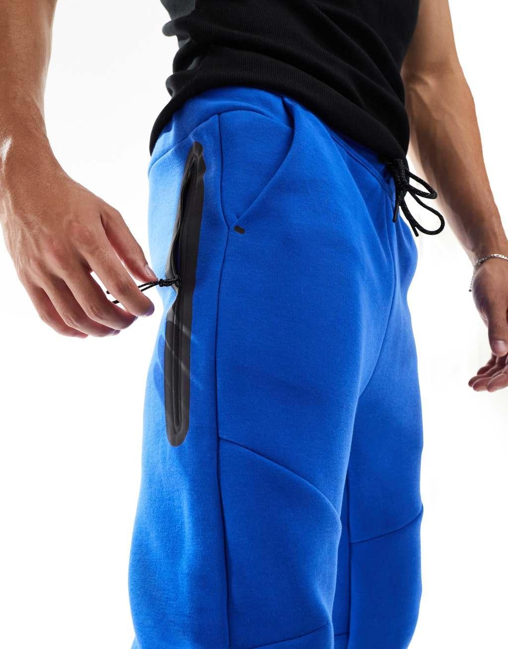 Nike Tech Fleece cuffed sweatpants in blue Product Image