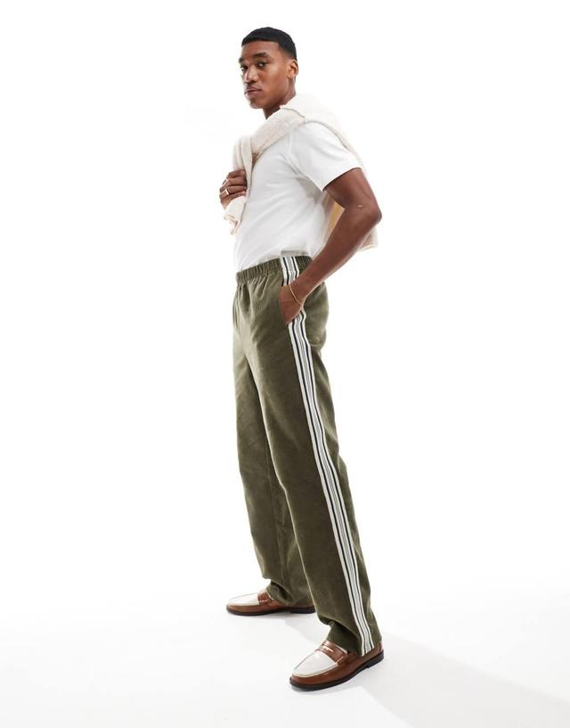 ASOS DESIGN pull on relaxed pants in green corduroy with stripe detail Product Image