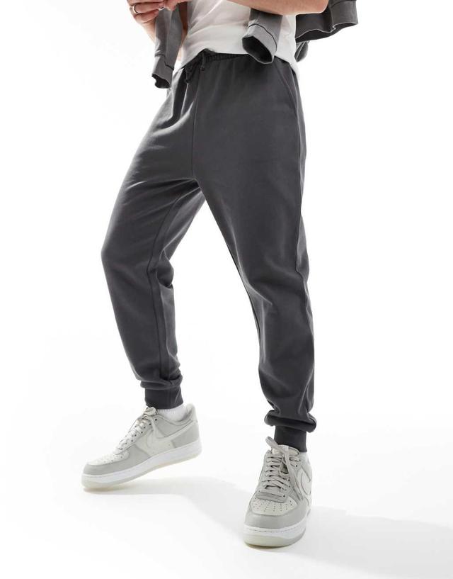 ASOS DESIGN essential tapered sweatpants in washed black Product Image