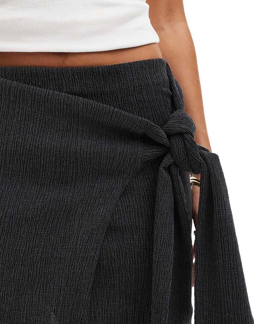 ASOS DESIGN textured mini skirt with tie detail in black Product Image