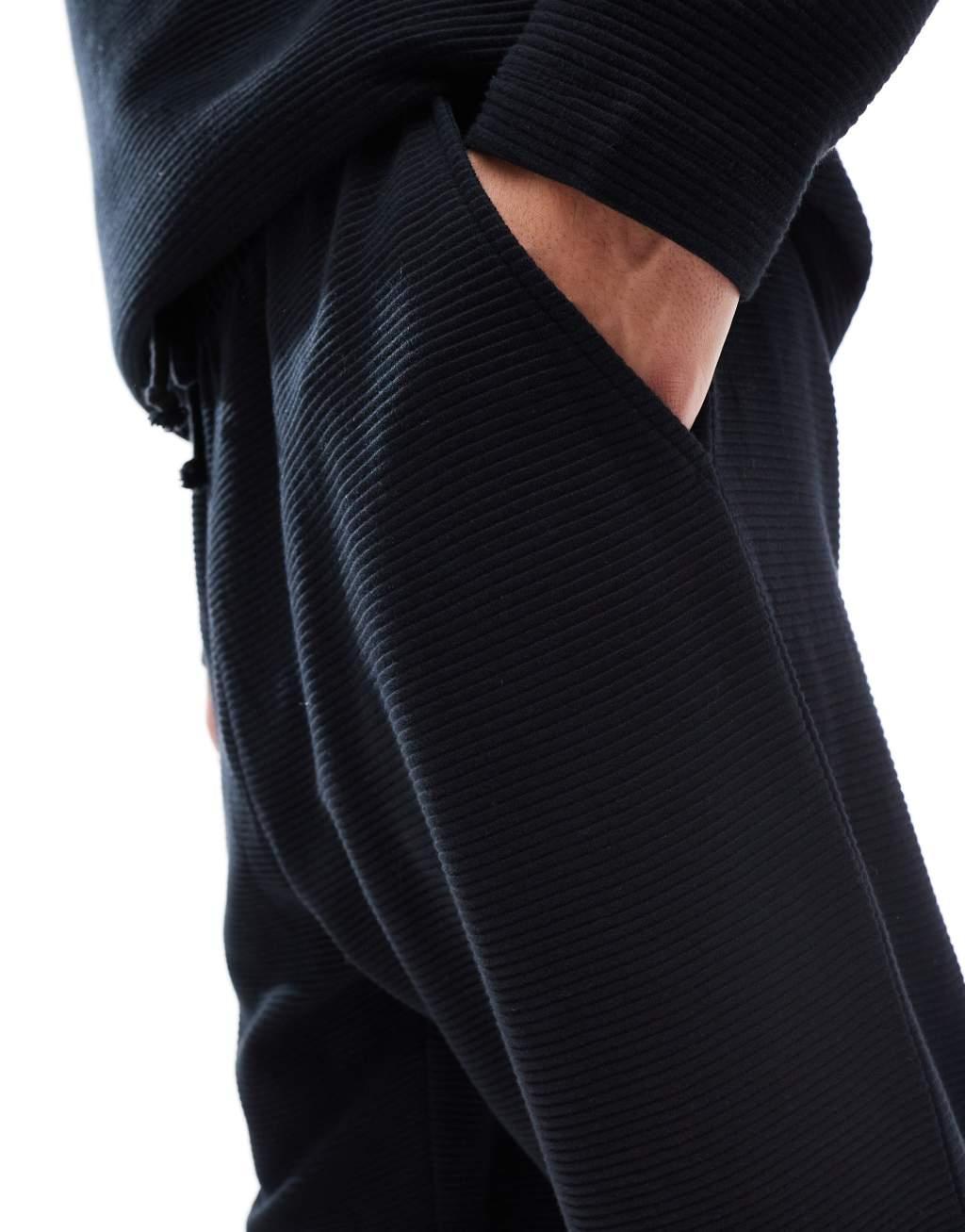 ASOS DESIGN tapered rib sweatpants in black Product Image