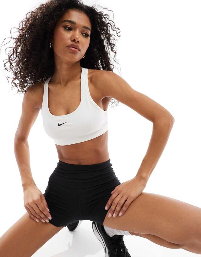 Nike Training Swoosh light support sports bra in white Product Image